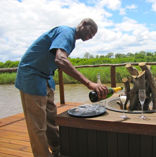 Reineck pouring champagne for our toast to Lion Sands